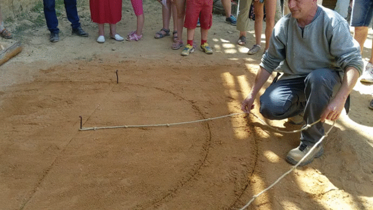 Drawing curves in the dirt with a knotted rope and stick