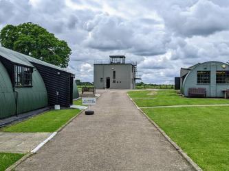 View of the museum site with the WW2 green control tower in the distance
