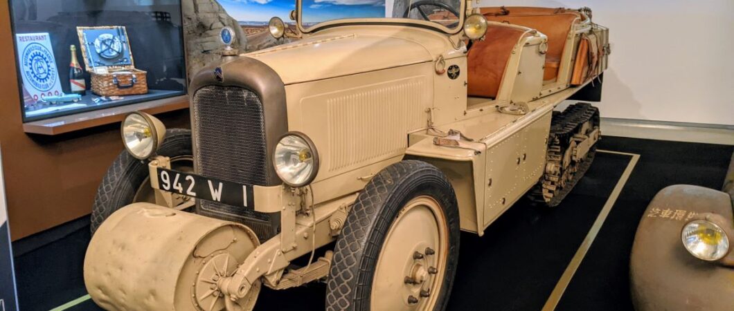 An open top, four seat half-track car painted in desert brown