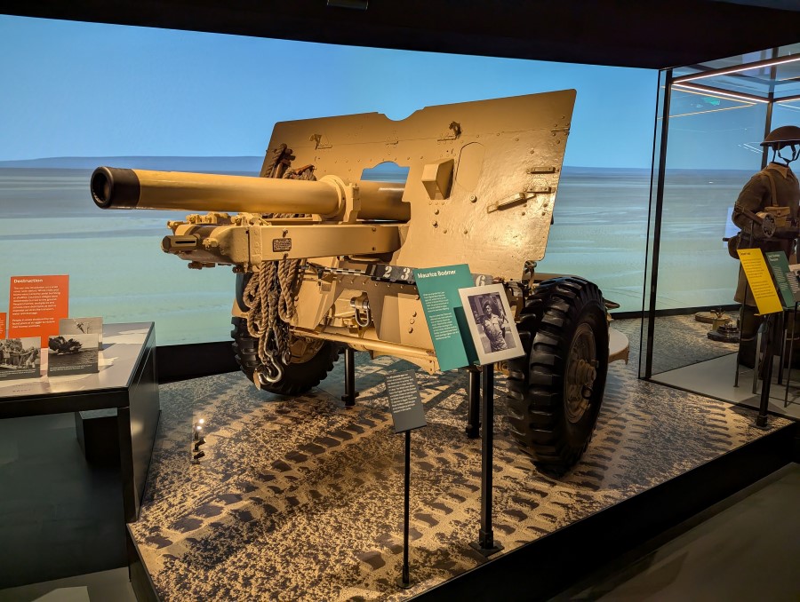 Sand coloured field gun set in a desert tableau