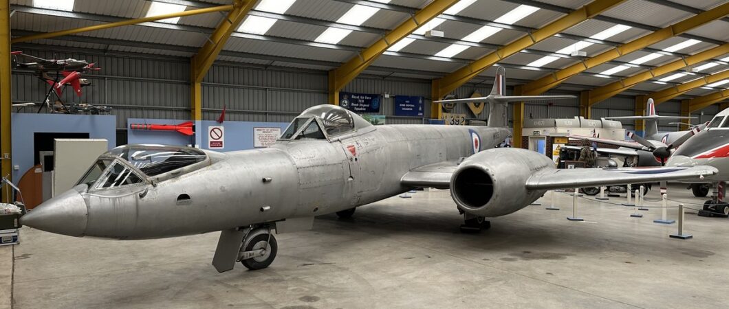 Grey 1950s twin jet with two bubble cockpit canopies