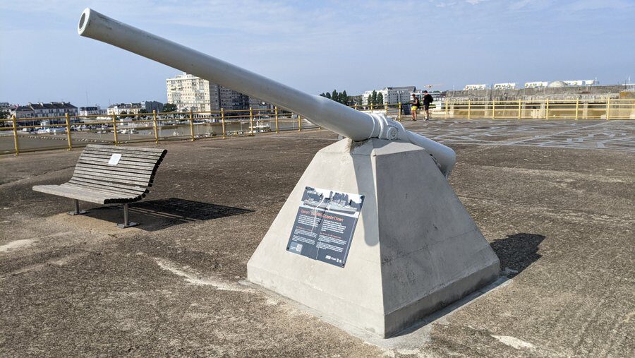 A naval gun mounted on a concrete plinth