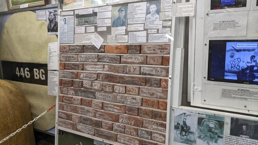 A small section of wall with signatures on the individual bricks