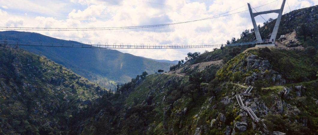 Thin suspension bridge crosses a steep ravine