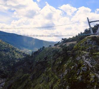 Thin suspension bridge crosses a steep ravine
