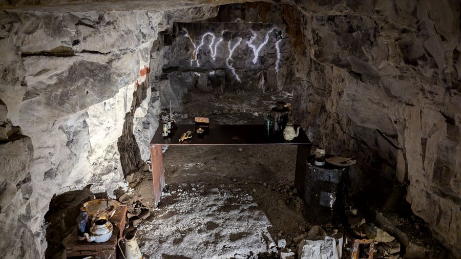 An alcove with a desk and sone rusty remains of equipment