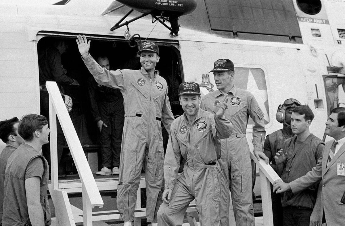 Apollo 13 crew stepping down from helicopter