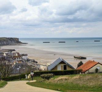 View looking down on the town of Arromanches, its beach, and Phoenix caissons out to sea