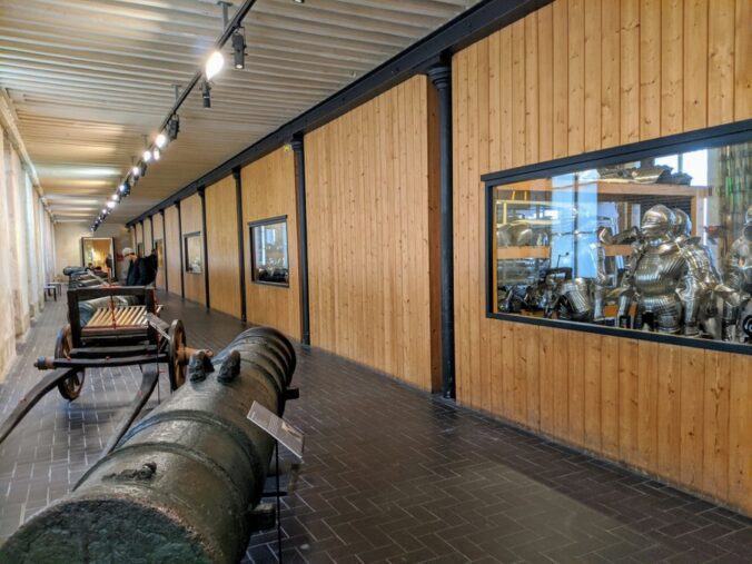 Corridor with canons and windows into the armour store