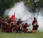 Smoke billows around a company of musketeers in red Royalist uniforms