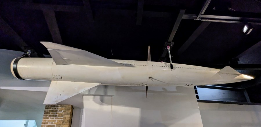 Light grey coloured missile suspended from the IWM ceiling