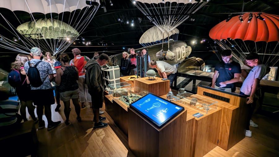 Visitors examine display cases on the mezzanine gallery