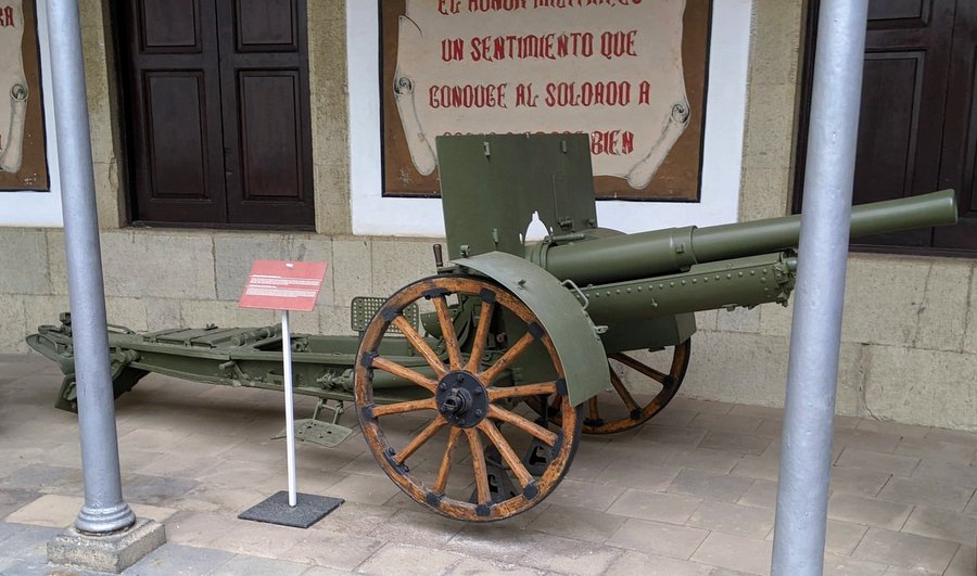 Green howitzer with wooden wheels