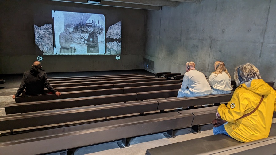 Visitors watch a video in the cinema