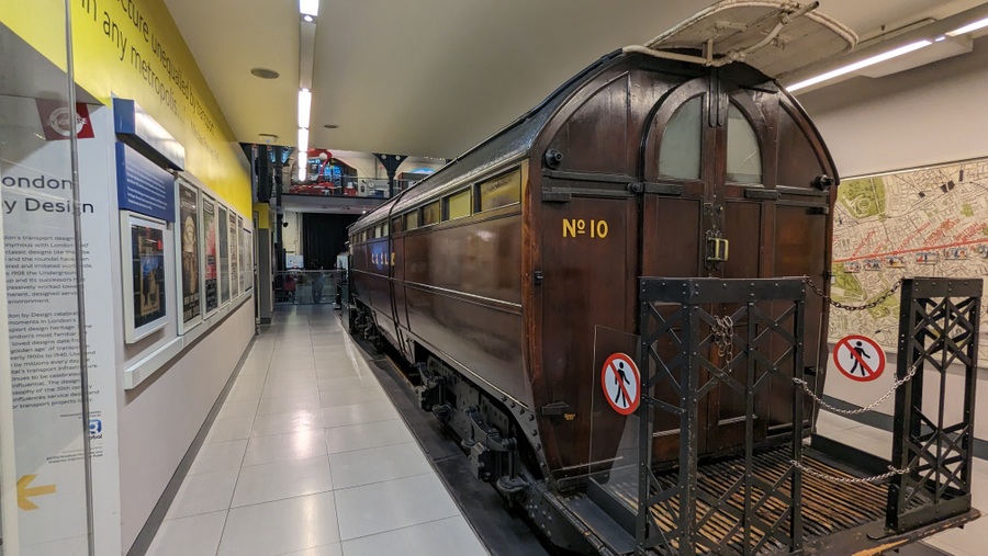 Dark brown railway coach with an ornate ironwork balcony at one end