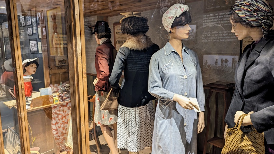 A queue of women (mannequins in a glass cabinet)