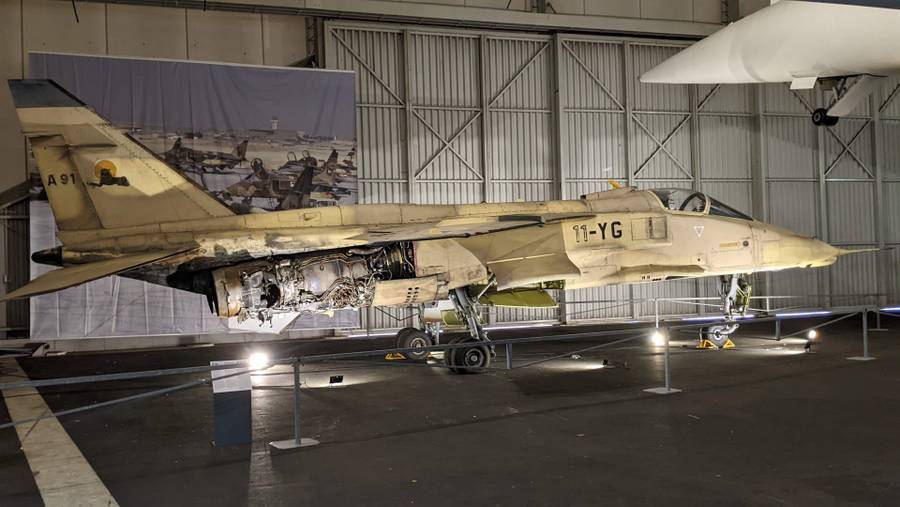 French Jaguar jet in desert camouflage with much of the starboard engine (nearest) blown away