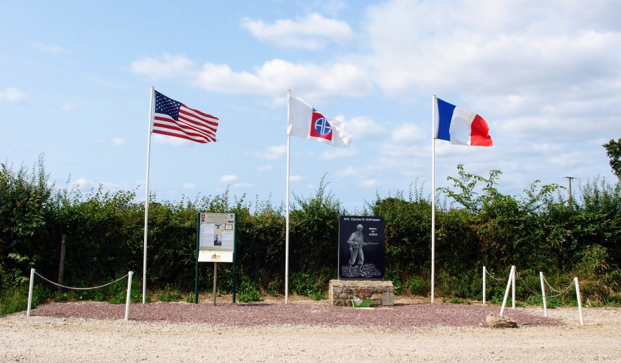 DeGlopper's roadside memorial with stèle, info board and flagpoles.