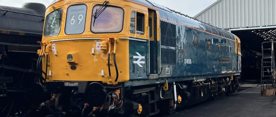 An old diesel locomotive in shiny British Rail colours (blue & yellow)