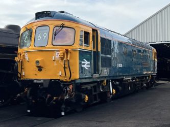 An old diesel locomotive in shiny British Rail colours (blue & yellow)