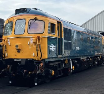An old diesel locomotive in shiny British Rail colours (blue & yellow)