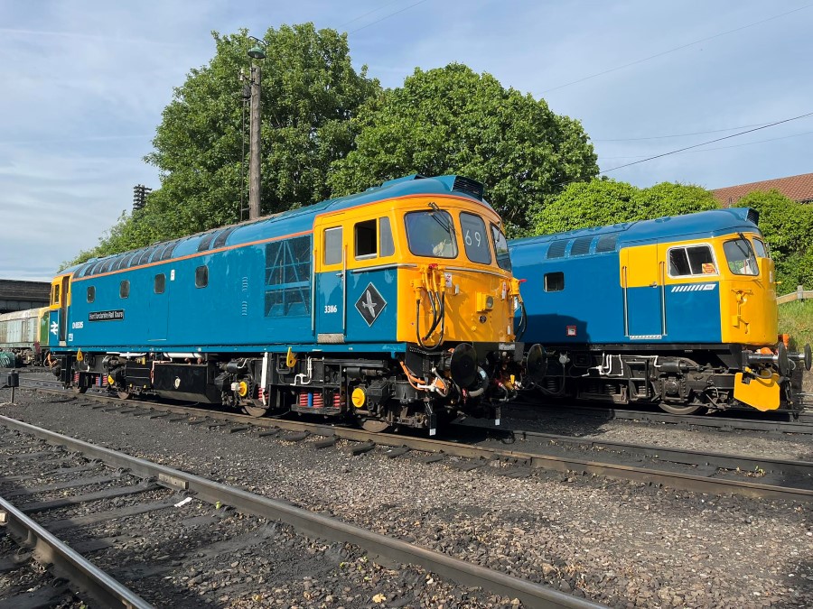 Two blue & yellow class 33 diesel locomotives side by side