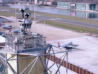 View of LCY's digital control tower in foreground with aircraft on the ground behind