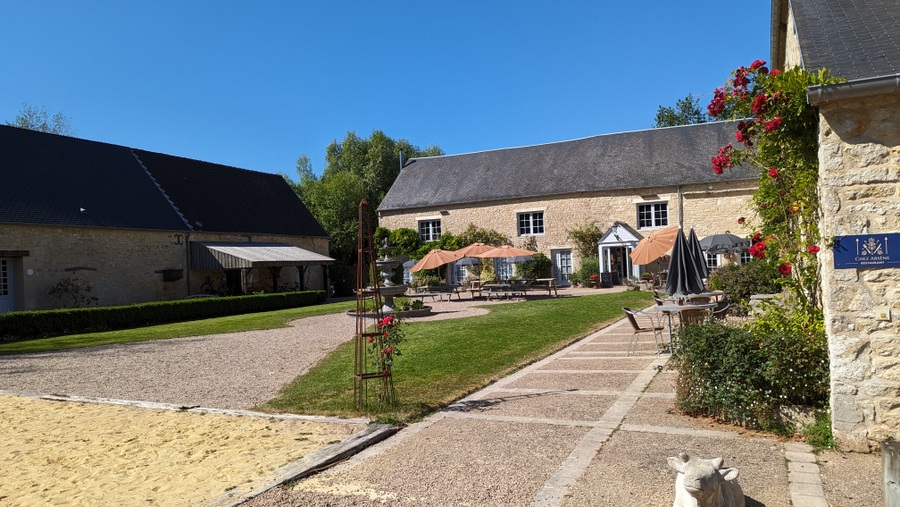 Converted farm courtyard with grass, trees and footpaths