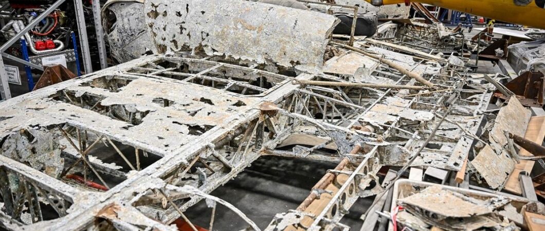 Corroded wreckage on a hanger floor