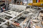 Corroded wreckage on a hanger floor