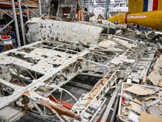 Corroded wreckage on a hanger floor