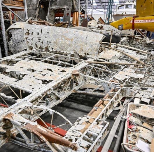 Corroded wreckage on a hanger floor