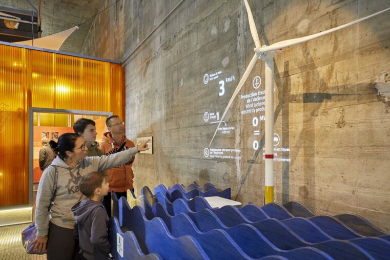 A family looking at the results of the artificially created wind , projected on the wall