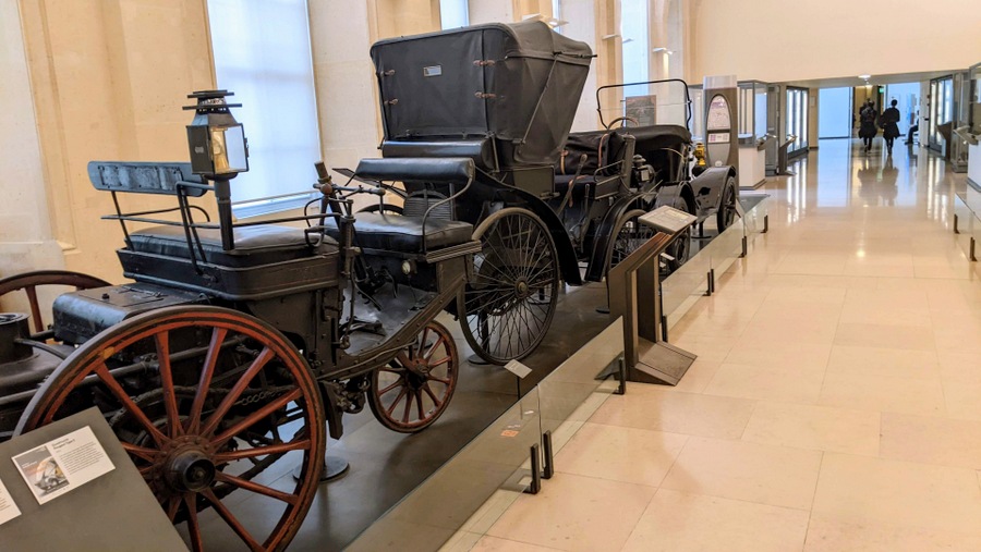 A row of classic antique automobiles from the 19th century