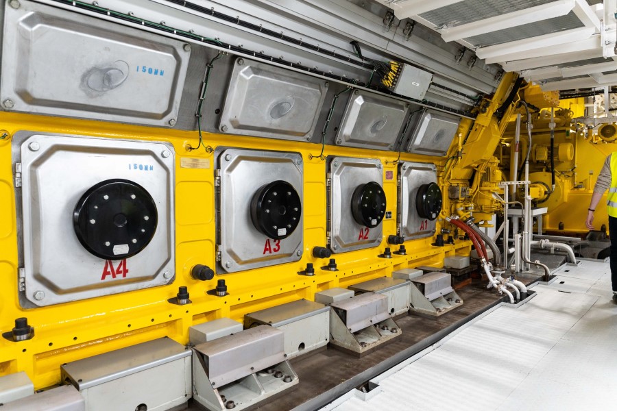 A large yellow engine with sliver access panels