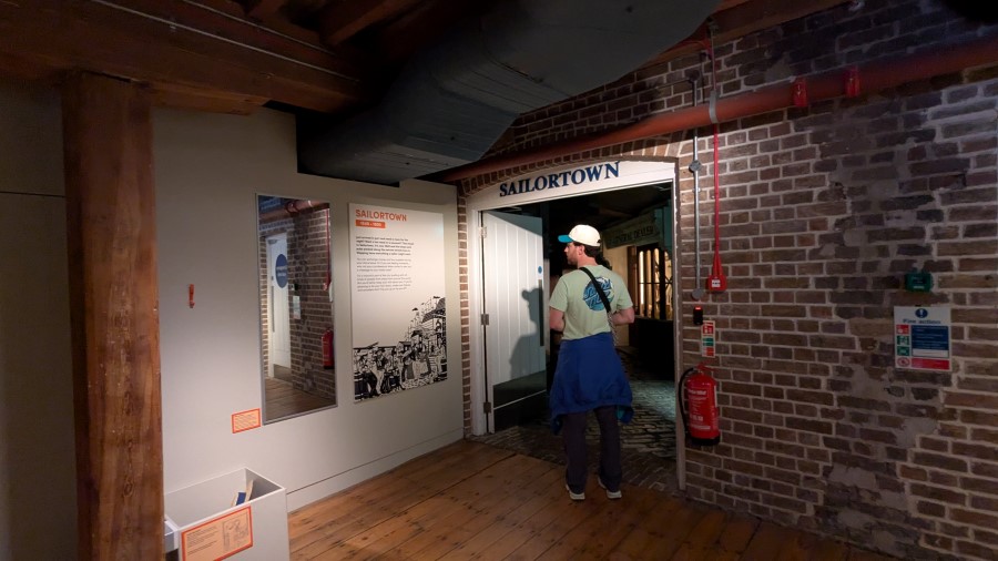 A man enters the dark alleyways of 'Sailor Town at the London Museum, Docklands