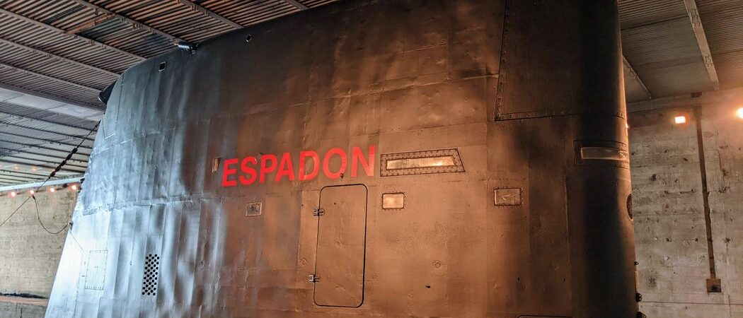 Black submarine conning tower with Espadon written in large red letters on it