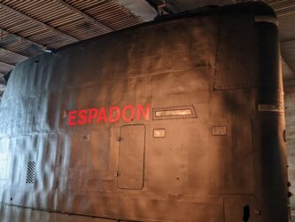 Black submarine conning tower with Espadon written in large red letters on it