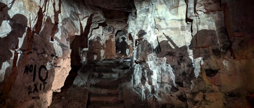 The silhouettes of British soldiers projected on the Wellington Quarry tunnel walls