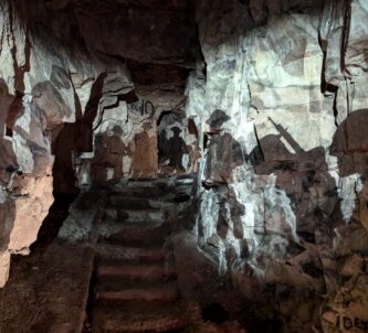 The silhouettes of British soldiers projected on the Wellington Quarry tunnel walls