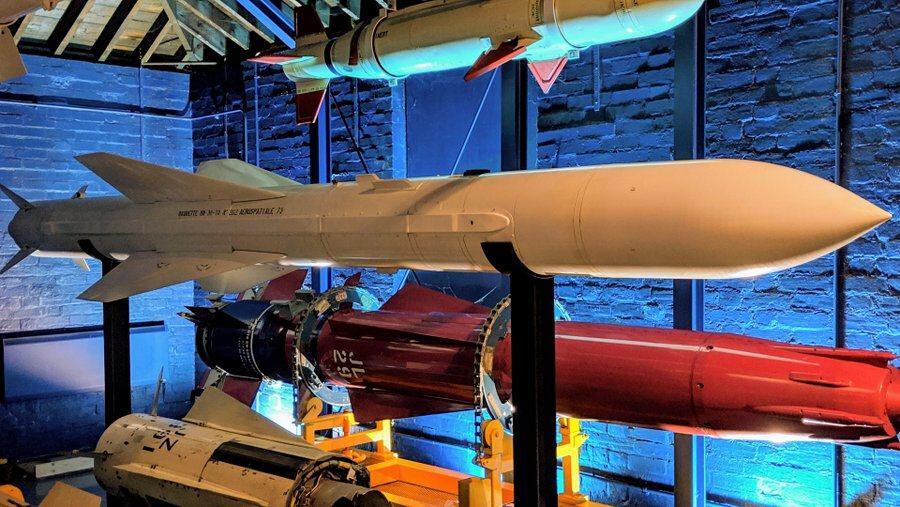 A large white missile surrounded by other missiles