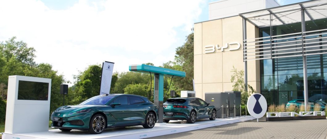 Two BYD cars under an electric charging stand