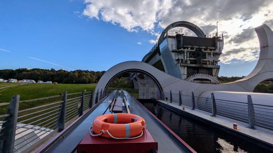 View of a narrowboat from the stern in a Falkirk Wheel gondola, halfway through the lift