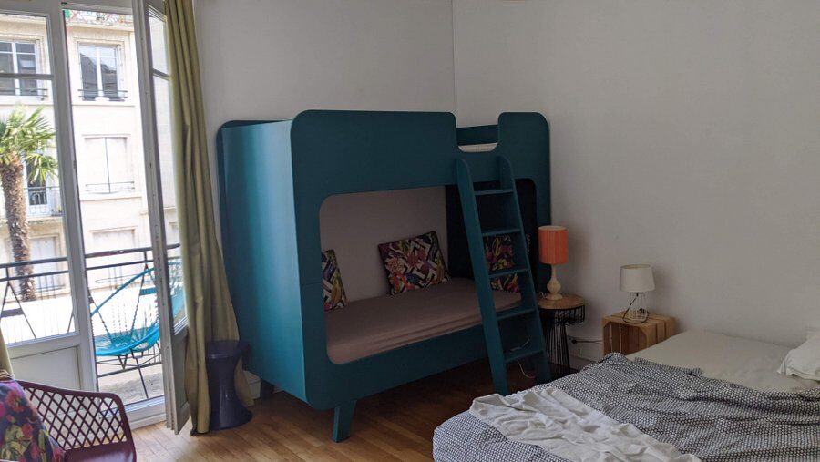 Blue children's bunk beds dominate the family room