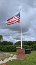 US flag on a brick memorial