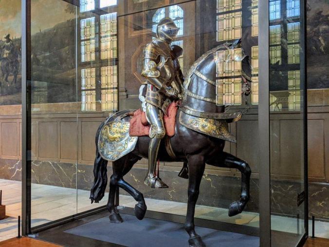 Armoured horse and rider in a glass display cabinet