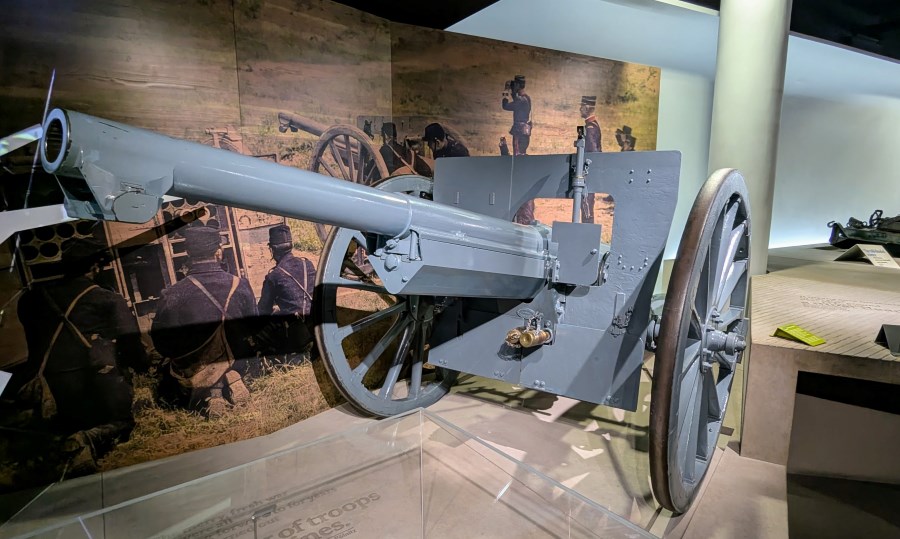 Grey WW1 field gun with a long barrel