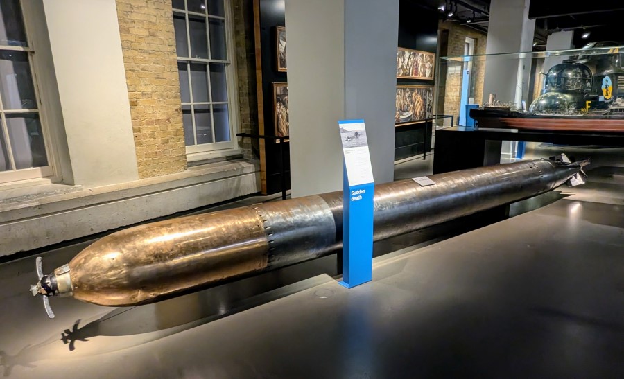 A long torpedo displayed on the floor at the IWM