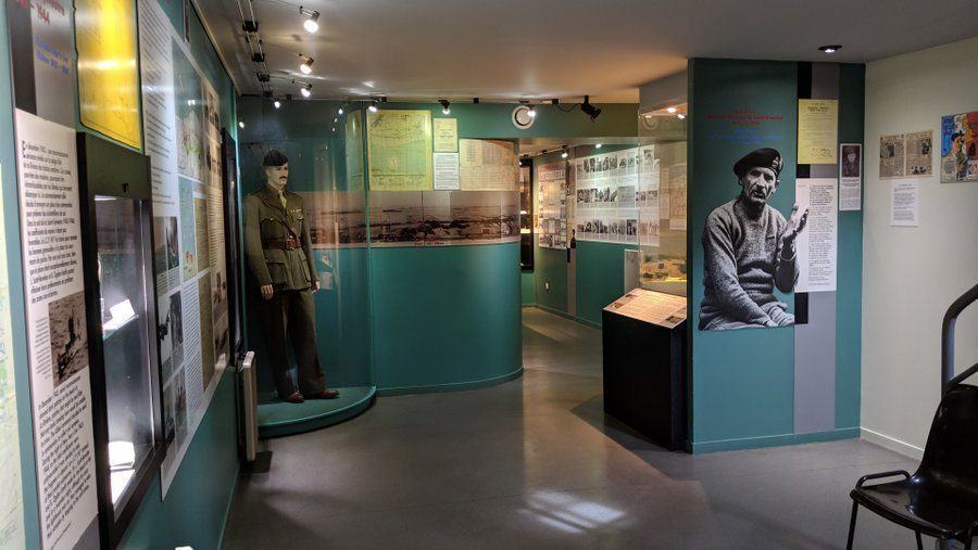 Museum gallery with display on the wall and a mannequin in a uniform