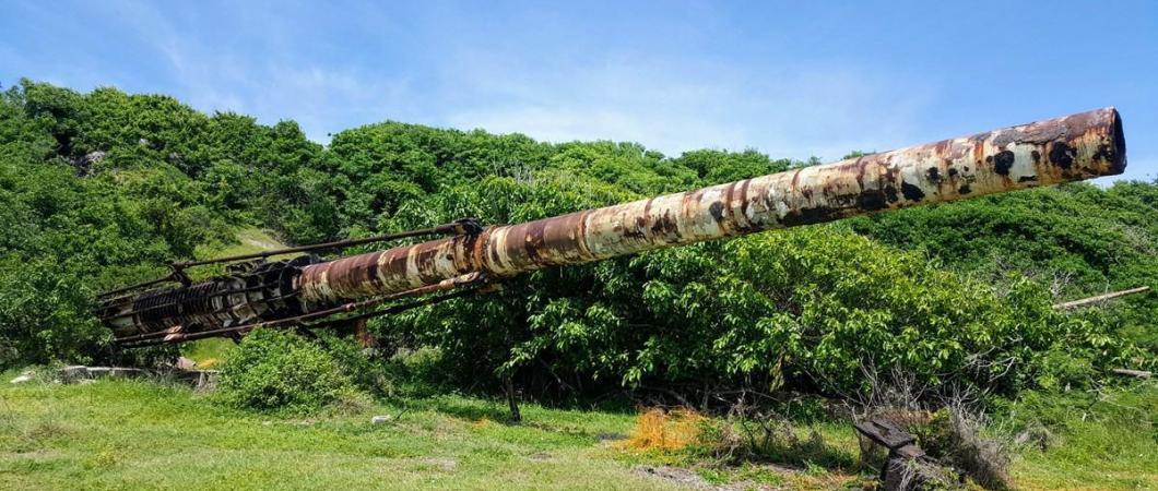 The white painted but rusting 120ft long HARP gun on Barbados ru